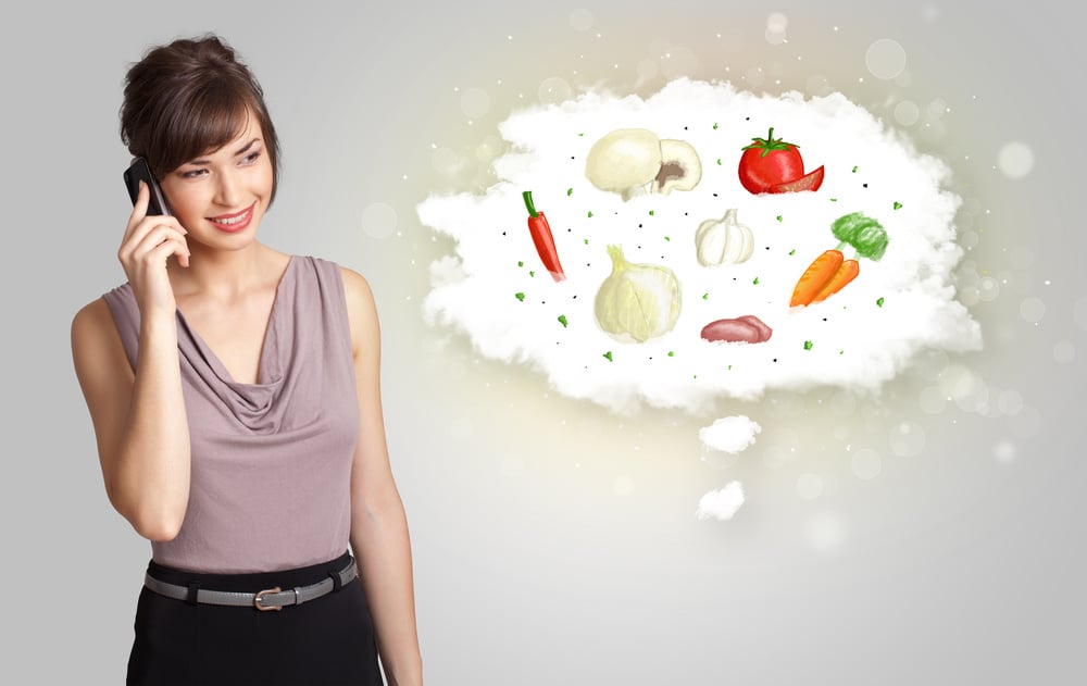 Pretty woman presenting a cloud of healthy nutritional vegetables concept